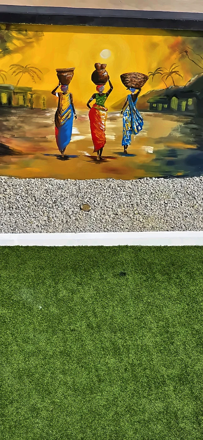 Mural of three women carrying baskets on their heads