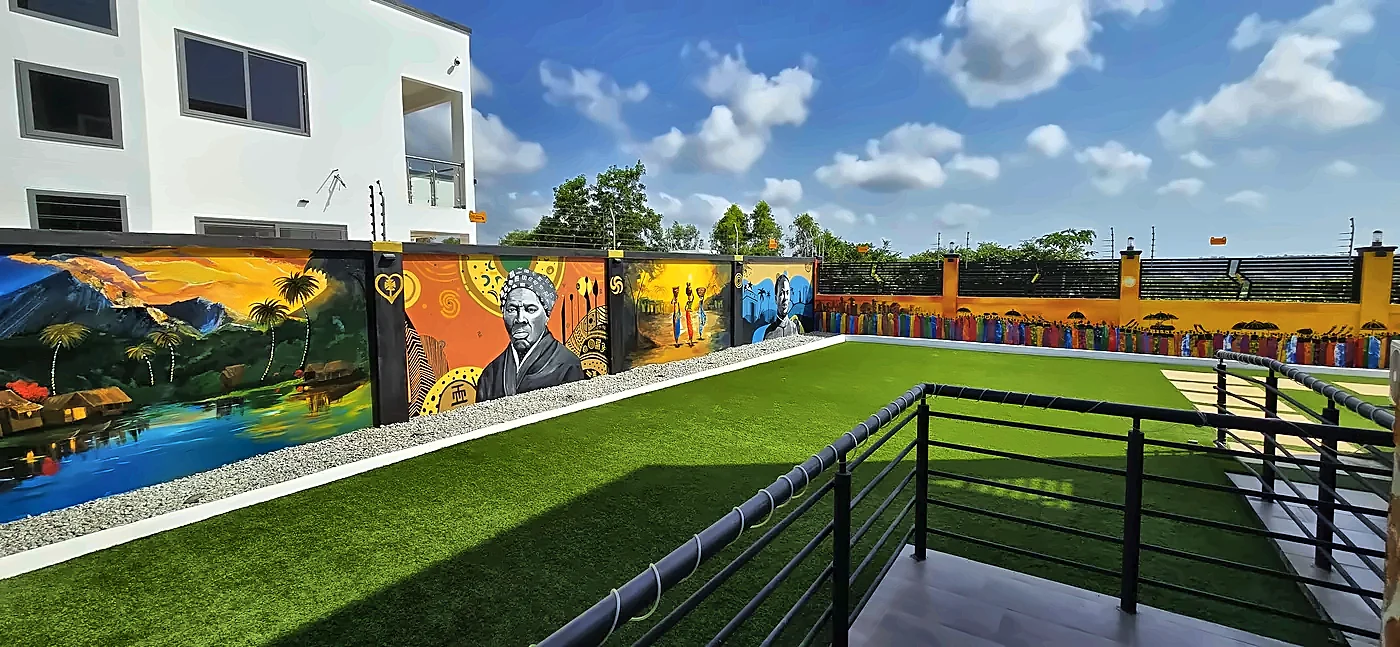 Rooftop terrace with railing, murals and blue sky