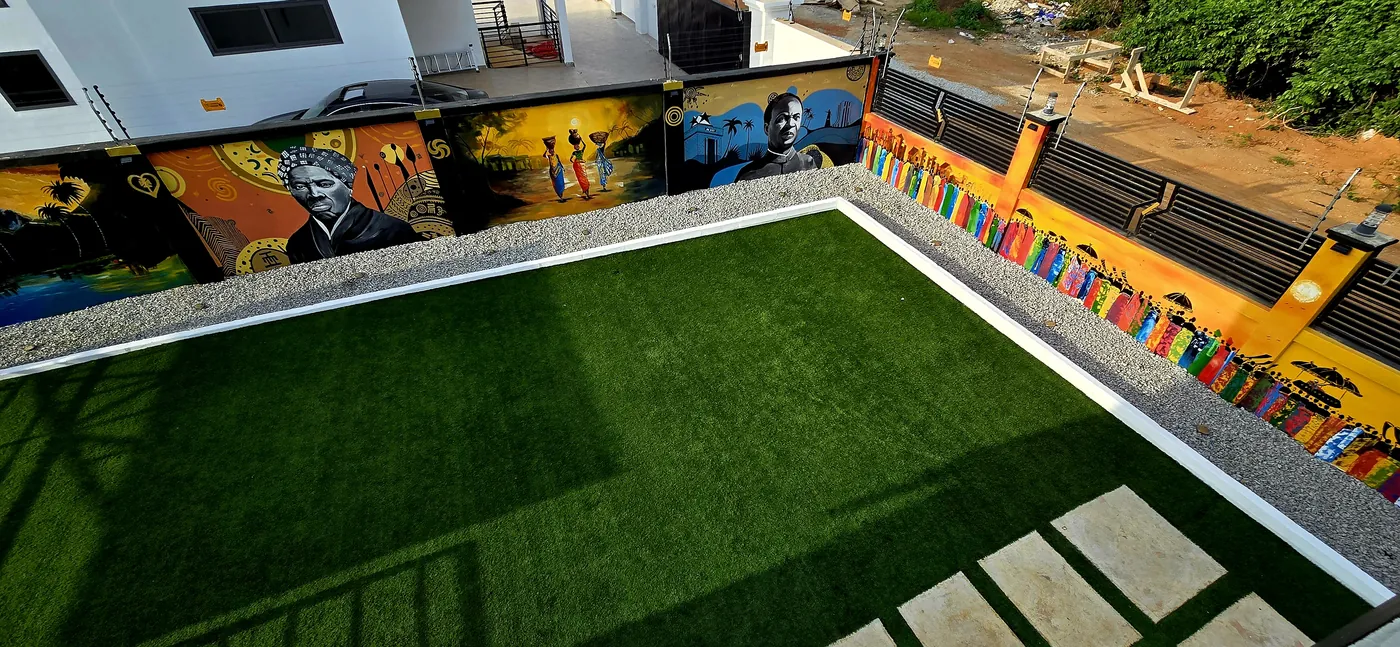Rooftop terrace with artificial turf and a long painted mural wall