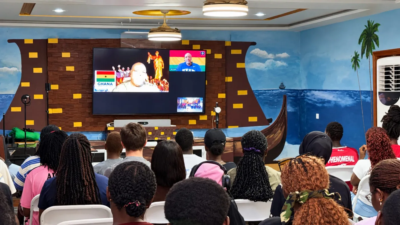 Students watching a live videoconference on the studio screen