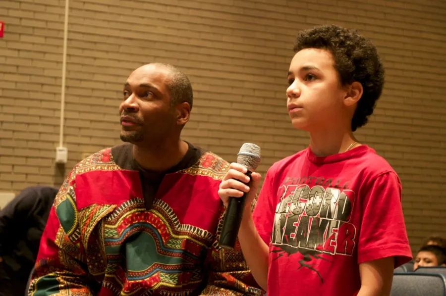 A student speaking into a microphone during a live session